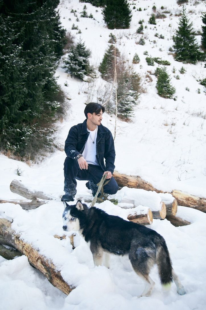 KESH jacket worn in snowy mountain landscape with husky